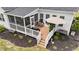 Aerial view of backyard deck featuring an umbrella, potted plants, and a cozy seating area at 257 Reese Dr, Willow Springs, NC 27592