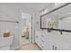 Bathroom with dual sinks, white cabinets and a view of the bedroom at 257 Reese Dr, Willow Springs, NC 27592