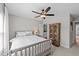 Bedroom with white decor, ceiling fan and a wooden furniture piece at 257 Reese Dr, Willow Springs, NC 27592
