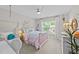 Relaxing bedroom with a swing, beautiful window view and white decor at 257 Reese Dr, Willow Springs, NC 27592