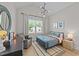 Bright bedroom with a cool space theme, modern chandelier and large window at 257 Reese Dr, Willow Springs, NC 27592