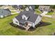 Aerial view of a well-maintained home with a screened porch, wooden deck, and manicured landscaping at 257 Reese Dr, Willow Springs, NC 27592