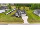 Aerial view of a beautifully landscaped property showcasing a well-maintained home with a long driveway at 257 Reese Dr, Willow Springs, NC 27592