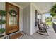 Charming front porch featuring rocking chairs and a decorative door, creating a welcoming entrance at 257 Reese Dr, Willow Springs, NC 27592