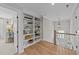Hallway with a view of a plant, with built in shelves, and wooden floors at 257 Reese Dr, Willow Springs, NC 27592