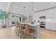 Bright kitchen with white cabinetry, large island, pendant lighting, and stainless steel appliances at 257 Reese Dr, Willow Springs, NC 27592