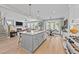 Open-concept kitchen with island, stainless steel appliances, and seamless flow to the living and dining areas at 257 Reese Dr, Willow Springs, NC 27592