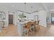 Bright kitchen featuring a large island with pendant lighting, white cabinets, and modern appliances at 257 Reese Dr, Willow Springs, NC 27592