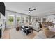 Spacious living room with large windows, offering ample natural light and a view of the outdoors at 257 Reese Dr, Willow Springs, NC 27592