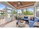 Inviting screened porch with comfortable blue seating, a wooden ceiling, and natural light at 257 Reese Dr, Willow Springs, NC 27592