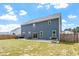Backyard featuring a green lawn, patio with grill, and a beautiful house with blue siding at 30 Dowdy Ct, Youngsville, NC 27596