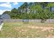 A spacious backyard features a trampoline, lush green lawn, and wood fence at 30 Dowdy Ct, Youngsville, NC 27596