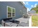 A home's backyard features an outdoor seating area, patio, and view of the home's exterior at 30 Dowdy Ct, Youngsville, NC 27596