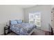 Bright bedroom with a queen sized bed, carpet, and large windows for natural light at 30 Dowdy Ct, Youngsville, NC 27596