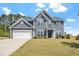 Charming two-story home with a well-manicured lawn and attached two car garage at 30 Dowdy Ct, Youngsville, NC 27596