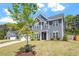 Attractive two-story home with a well-kept lawn and landscaping, under a cloudy, blue sky at 30 Dowdy Ct, Youngsville, NC 27596