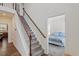 Welcoming foyer featuring hardwood floors, a staircase, and a glimpse of the bedroom at 30 Dowdy Ct, Youngsville, NC 27596