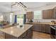 Well-equipped kitchen with granite countertops and a view to the fenced backyard at 30 Dowdy Ct, Youngsville, NC 27596