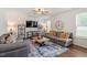 Cozy living room with sectional seating, neutral tones, and a view to the backyard at 30 Dowdy Ct, Youngsville, NC 27596