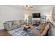 Inviting living room with comfortable seating and a large area rug at 30 Dowdy Ct, Youngsville, NC 27596