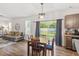 Open-concept living area with a dining area and a view to the backyard at 30 Dowdy Ct, Youngsville, NC 27596