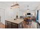 Open-concept living area flows into a dining space with stylish pendant lighting at 30 Dowdy Ct, Youngsville, NC 27596