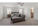 Spacious main bedroom with natural light, carpet floors, and seating area at 30 Dowdy Ct, Youngsville, NC 27596