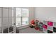 Versatile room with a large window, neutral carpeting, and a closet with storage at 30 Dowdy Ct, Youngsville, NC 27596
