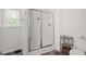The walk-in shower features glass doors, white tile, and is spacious at 30 Dowdy Ct, Youngsville, NC 27596