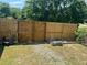 Fenced backyard with grass, gravel path, mature trees, and garden beds at 307 S Smithfield Rd, Knightdale, NC 27545