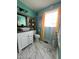 Updated bathroom with modern vanity, fixtures, and unique tile flooring at 307 S Smithfield Rd, Knightdale, NC 27545