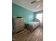 Bright bedroom features stylish furniture, wood floors, and a calming, colorful wall at 307 S Smithfield Rd, Knightdale, NC 27545