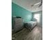 Bright bedroom features stylish furniture, wood floors, and a calming, colorful wall at 307 S Smithfield Rd, Knightdale, NC 27545