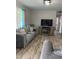 Inviting living room features sleek furniture, a fireplace, and wood-look flooring at 307 S Smithfield Rd, Knightdale, NC 27545