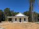 Newly constructed single story home featuring white siding and wooden support beams on the front porch at 329 Green Pines Estates Dr, Kenly, NC 27542