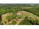 Expansive aerial view showcases a sprawling estate with a pool, surrounded by lush greenery and mature trees at 342 Mcleod Rd, Broadway, NC 27505