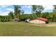Property boasts multiple barns and outbuildings amidst lush greenery on a sprawling lot at 342 Mcleod Rd, Broadway, NC 27505