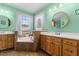Inviting bathroom with double sinks, a soaking tub nestled between windows, and elegant tile work at 342 Mcleod Rd, Broadway, NC 27505