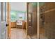 Spacious bathroom features a glass shower, double sink vanity, and a luxurious soaking tub with large windows at 342 Mcleod Rd, Broadway, NC 27505