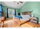 Warm bedroom featuring hardwood floors, a rustic wooden bed frame, and an abundance of natural light at 342 Mcleod Rd, Broadway, NC 27505