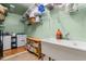 Functional laundry room with ample shelving, storage, a utility sink, and modern washer and dryer units at 342 Mcleod Rd, Broadway, NC 27505