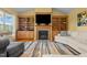 Living room with a cozy fireplace, custom built-ins, and an abundance of natural light at 342 Mcleod Rd, Broadway, NC 27505