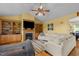 Comfortable living room featuring a fireplace, custom shelves, and stylish ceiling fan at 342 Mcleod Rd, Broadway, NC 27505