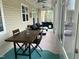 Spacious covered porch with dining and lounge area, perfect for outdoor entertaining and relaxation at 342 Mcleod Rd, Broadway, NC 27505