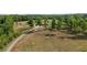Scenic property view of a home with red roof amid trees, revealing a sprawling lawn at 342 Mcleod Rd, Broadway, NC 27505