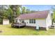 Expansive backyard featuring a deck, lush lawn, and storage shed at 35 Vauxhall Ct, Youngsville, NC 27596