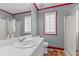 Bathroom featuring a shower with glass door and a red border around the window and mirror at 35 Vauxhall Ct, Youngsville, NC 27596