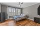 Comfortable bedroom filled with natural light and stylish wood-look flooring at 35 Vauxhall Ct, Youngsville, NC 27596