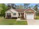 Charming single-story home with stone accents, a well-maintained lawn, and an attached garage at 35 Vauxhall Ct, Youngsville, NC 27596