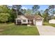 Single-story home featuring charming curb appeal with stone details, a garage, and a well-kept lawn at 35 Vauxhall Ct, Youngsville, NC 27596
